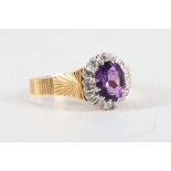 An 18 carat yellow gold, diamond, and amethyst oval cluster ring. Size: P 1/2 Weight, 5.3g