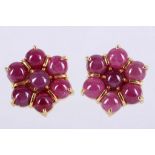 A pair of yellow metal and cabouchon ruby floral cluster ear studs. D: 1cm