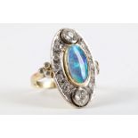 An impressive 14 carat yellow gold, black opal, and diamond cocktail ring, having oval cabouchon