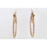 A pair of 18 carat yellow gold and diamond hoop earrings, set round cut diamonds to the exterior and