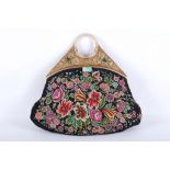 An unusual early 20th century Asian gilt metal mounted petit point embroidered handbag, having