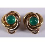 A pair of tri-coloured metal swirl earrings, each centred with circular cabouchon cut green jade. D: