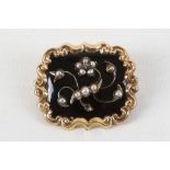 A Victorian yellow metal mourning brooch set with seed pearls on black ground, reverse set with