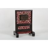 A small Chinese table screen with pierced surround to an inset carved tortoiseshell box.