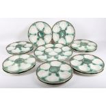 A set of 20th Century longchamp Paris majolica oyster plates in green and white with brown edging,