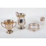 Four items of hallmarked silver to include a 3/4 pint mug, a twin handled trophy cup, a silver