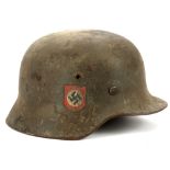 A German WWII helmet, M35 combat field police helmet, double decals, later black leather liner.