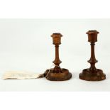 A pair of very early 20th Century carved wood Boer War trench art candlesticks, having original