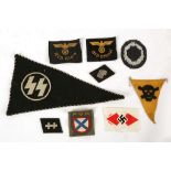 Two Kriegsmarine patch badges, Luftwaffe laurel badge, mine warning triangle, NSDAP unused