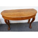A 19th Century figured oak console table, having demi-lune mould top on scroll carved front legs,