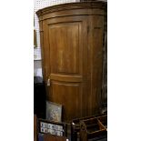 An antique pine bow fronted corner cabinet, with single panelled door, 110cm wide.