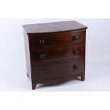 A Victorian mahogany and cross banded miniature chest of three long drawers, 32cm wide.