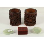 A pair of Chinese Bitong carved bamboo brush pots with figural decoration amongst a tree cliff