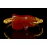 AN EGYPTIAN GOLD AND CARNELIAN UDJAT EYE SWIVEL RING 18th Dynasty, circa 1543–1292 BC The amulet
