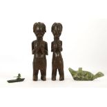 TWO GREEN STONE INUIT SCULPTURES, CANADA One of a seal, 21.5cm long; the other of an Inuit hunter in