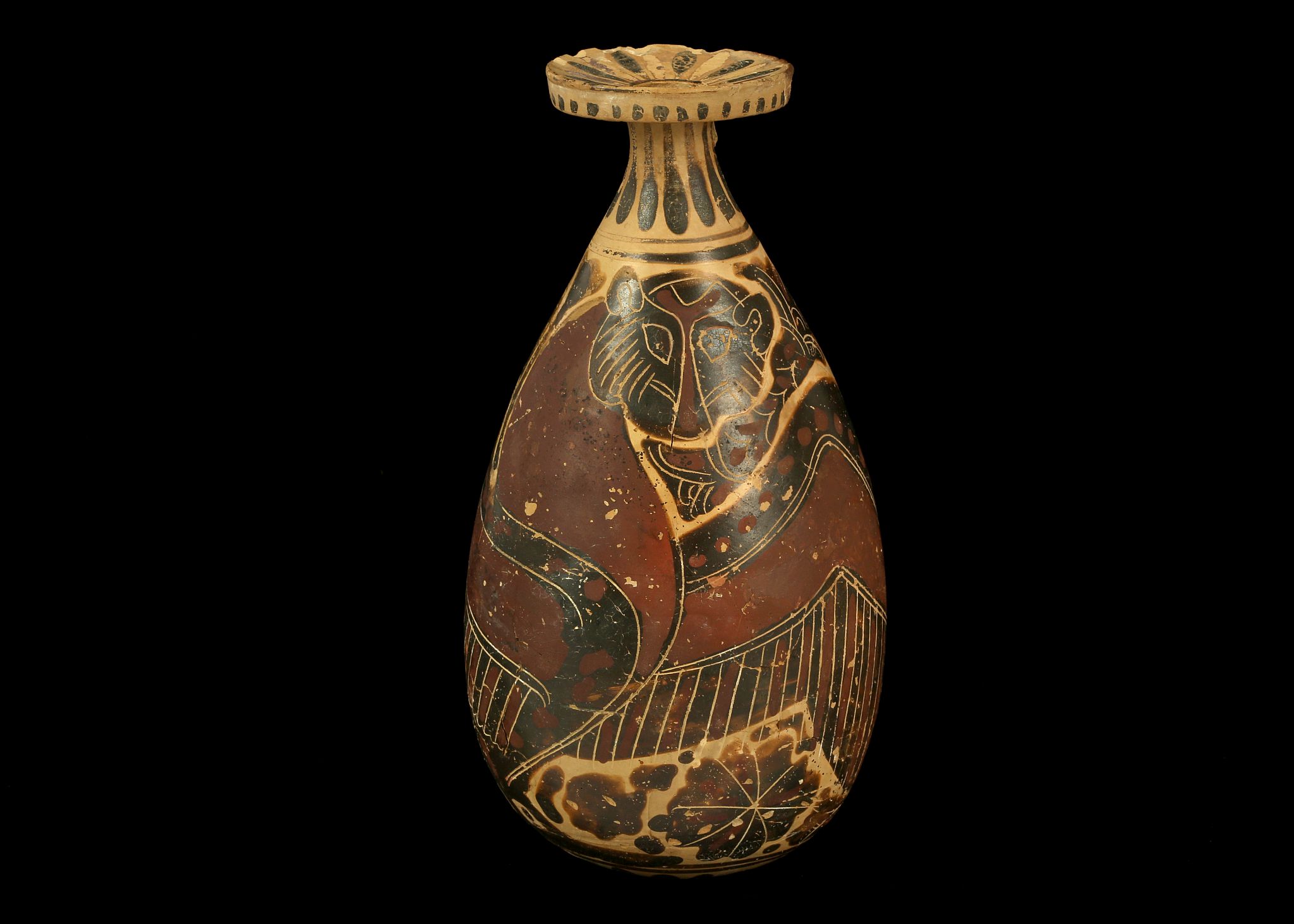 A CORINTHIAN POTTERY ALABASTRON Circa 6th Century B.C. Decorated in crimson and brown, with added