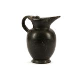 AN ETRUSCAN BUCCHERO OINOCHOE Circa 6th Century B.C. The later handle joining the trefoil lip,