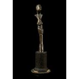 A BRONZE ANTHROPOMORPHIC FINIAL Possibly Celtic The slender highly stylised figure with large eyes