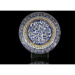 A QAJAR UNDERGLAZE-PAINTED POTTERY DISH IN THE IZNIK STYLE Persia, 19th Century Decorated with an