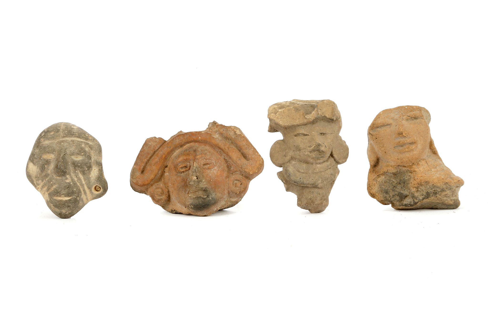 FOUR PRE-COLUMBIAN TERRACOTTA HEADS, MEXICO Including two Teotihyacan examples, an Aztec head of a
