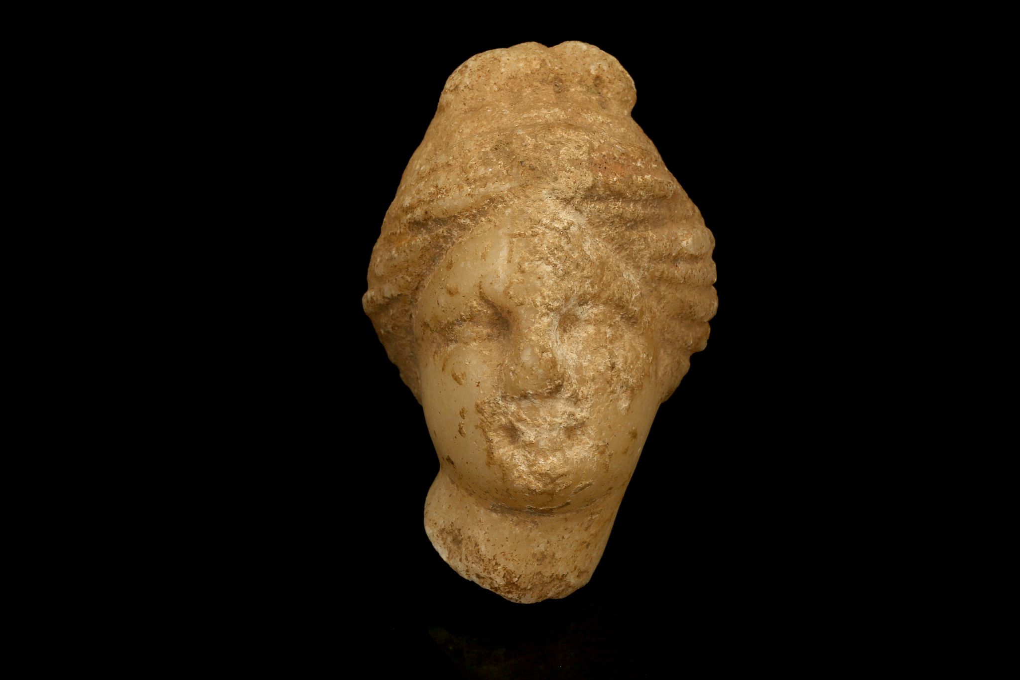 A SMALL ROMAN MARBLE HEAD OF APHRODITE Circa 2nd Century A.D. The goddess depicted with centrally-