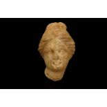 A SMALL ROMAN MARBLE HEAD OF APHRODITE Circa 2nd Century A.D. The goddess depicted with centrally-