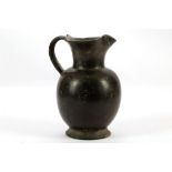 AN ETRUSCAN BUCCHERO OINOCHOE Circa 6th Century B.C. With spherical body and trefoil lip, 20.5cm