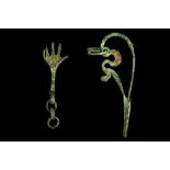 TWO ETRUSCAN BRONZE ITEMS Circa 6th Century B.C. Including a votive hand, 7cm long, and a fibula,