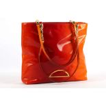 CHRISTIAN DIOR ORANGE PATENT TOTE, with gilt metal pebble style strap, 32cm wide, 27cm high