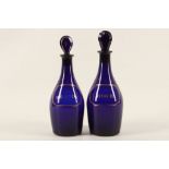 A pair of Georgian Bristol Blue decanters with names 'Shrub' & 'Brandy' in gold. (2)
