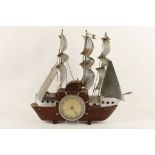 A 1950's clock modelled as a galleon in wood and chrome.