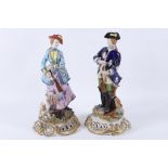 A pair of early 20th Century Naples porcelain figurines of hunters (2).