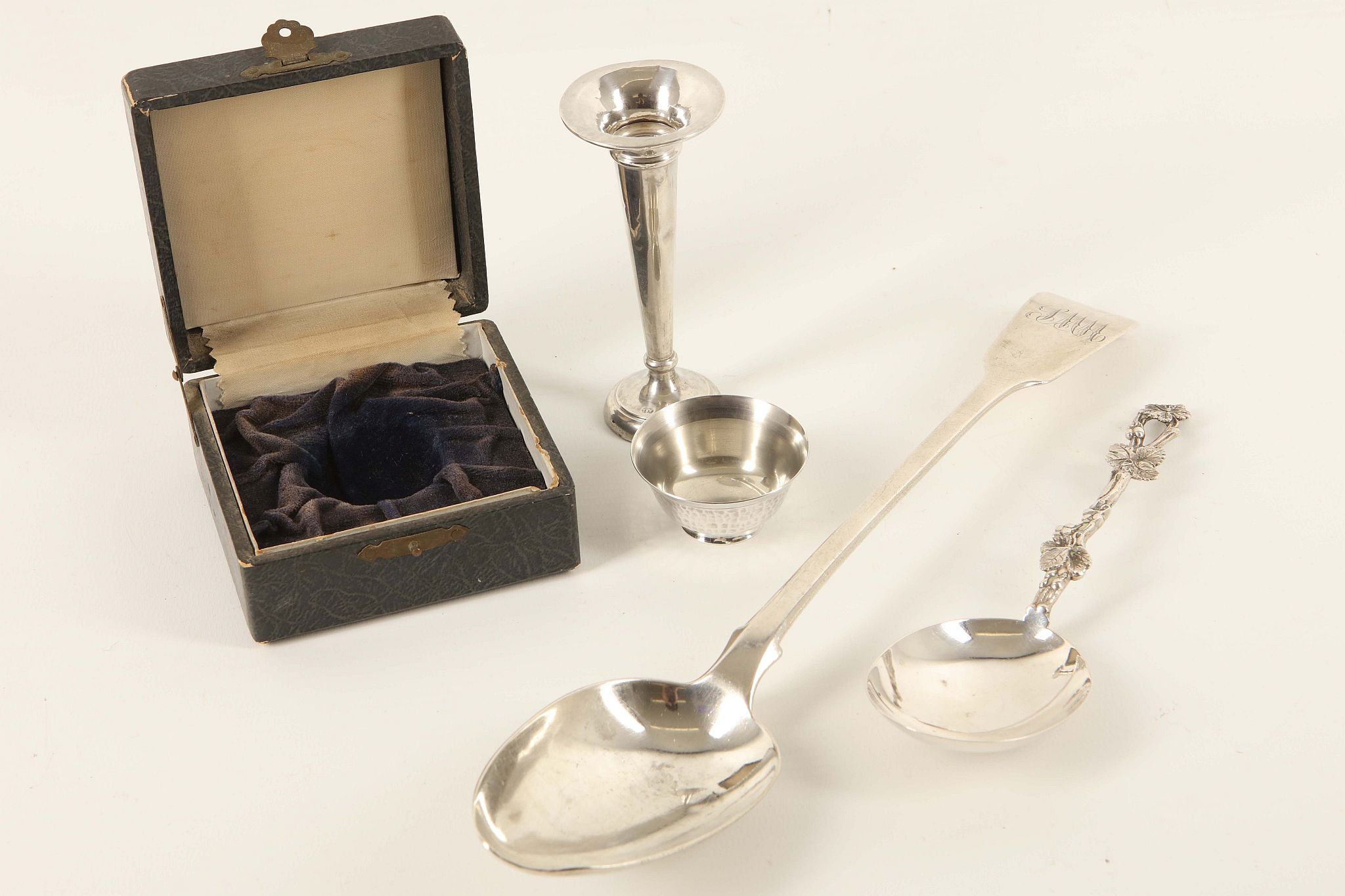 A Georgian silver basting spoon, London 1821, sold with a trumpet bud vase, a 17th Century Dutch