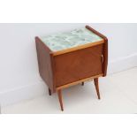 A 1950s ITALIAN WALNUT BEDSIDE CABINET, manufactured by Dassi, with marbled green glass top, and