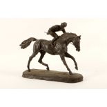 A Spelter figure of a jockey on horseback.