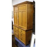 A 19th Century light oak cupboard with twin panelled doors over six short drawers  151 wide