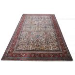 An Old Persian rug, with cream floral ground and red border