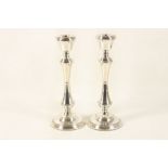 A pair of large size modern hallmarked silver candlesticks in George III style, raised on stepped