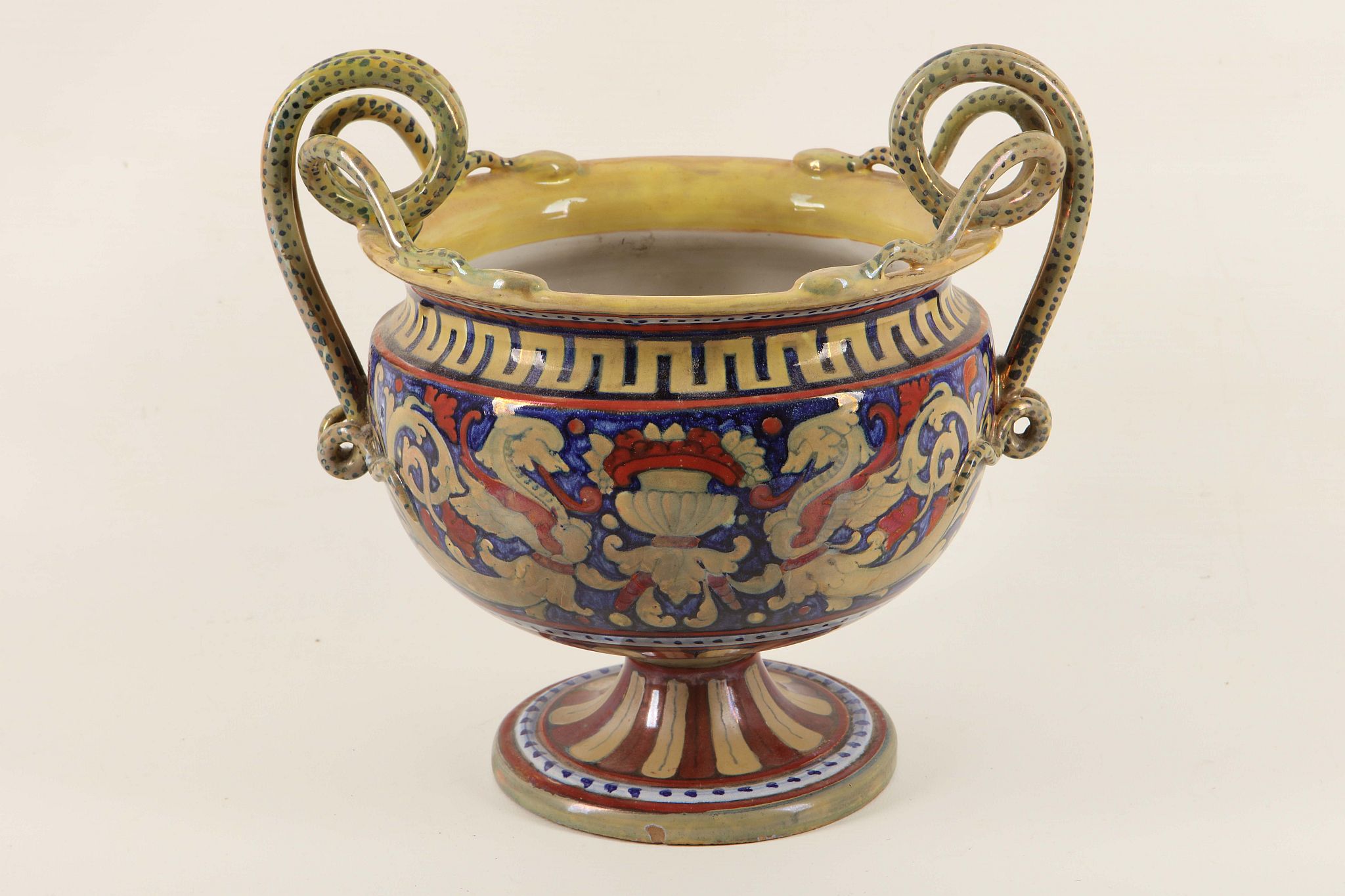 A 19th Century Italian majolica vase with twin snake handles, decorated in lustrous glazes in