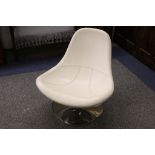 A white leather chair with chrome base.