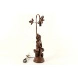 A French bronzed spelter figural table lamp, modelled as a young girl seated on a wall, 5.5cm