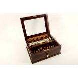 A French compendium in a brass edged and glass topped polished mahogany box. Set comprises Chess,