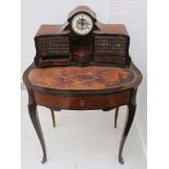 A late 19th century Kingwood bonheur de jour fitted with a clock the superstructure with faux