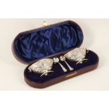 A leather boxed late Victorian pair of hallmarked silver salts and matching spoons, both having