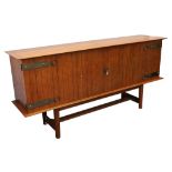 A 1950s FRENCH SIDEBOARD, manufactured by Maison Lancel, in teak, with routed design and steel and