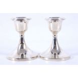 A pair of Art Deco hallmarked silver candlesticks, of tapering columns, raised on bakelite bases