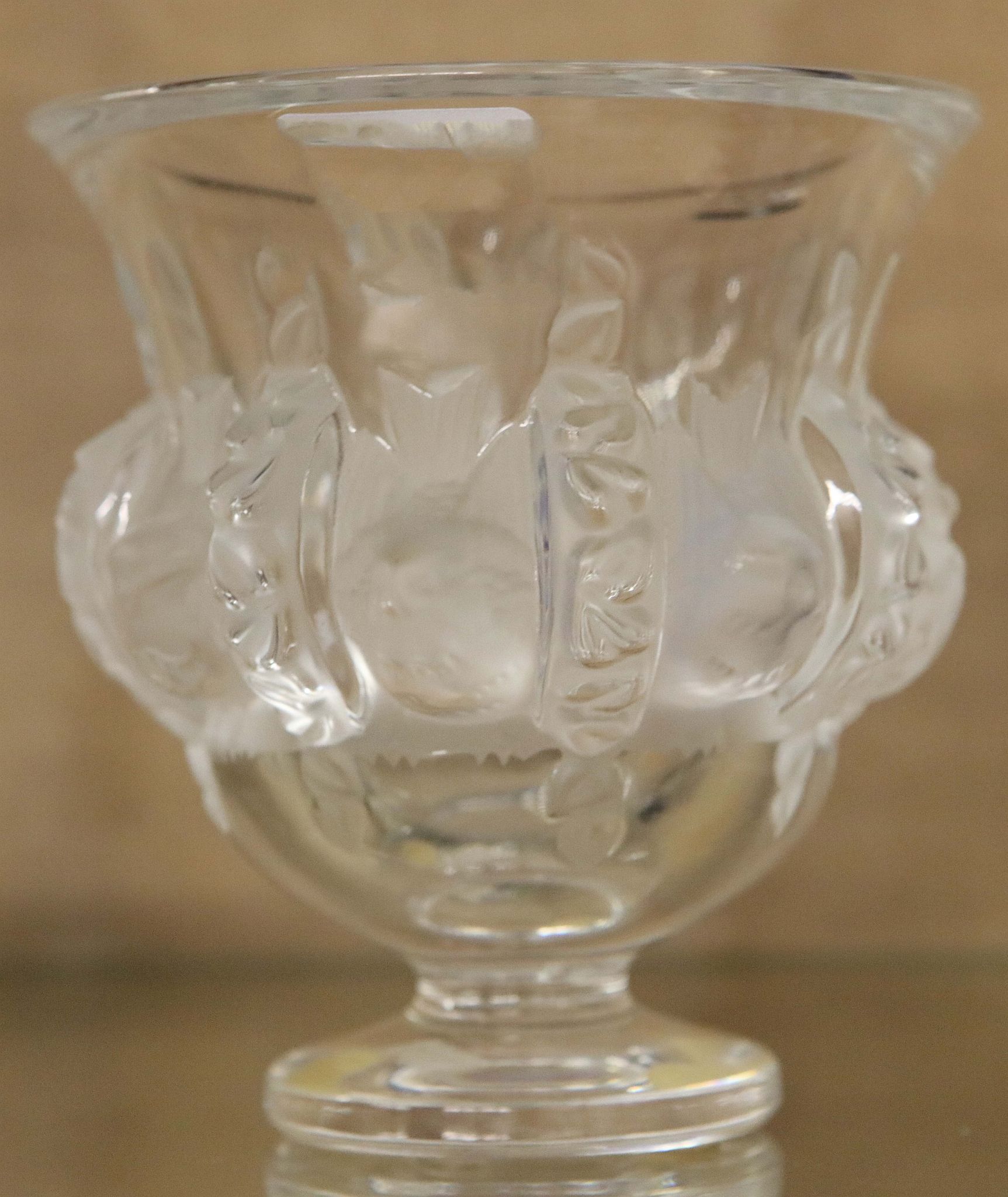 A Lalique - France campana form glass vase of squat proportions and decorated in the round with