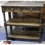 An Edwardian carved oak unit with drawers over shelves over turned and carved legs. 107x110x45cm