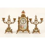 A late 19th Century gilt metal and painted porcelain mounted three piece clock garniture, painted