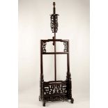 A Chinese carved and pierced wood lamp, 135cm high.